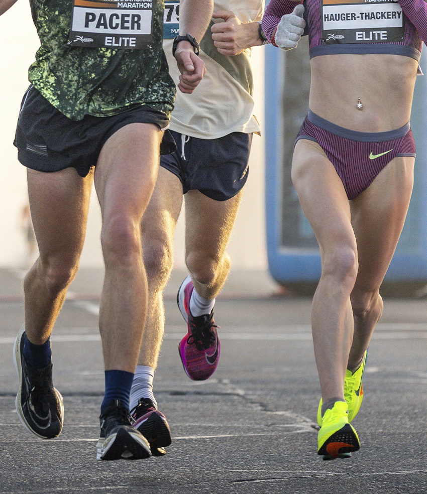 Runners close up of stride length during race.