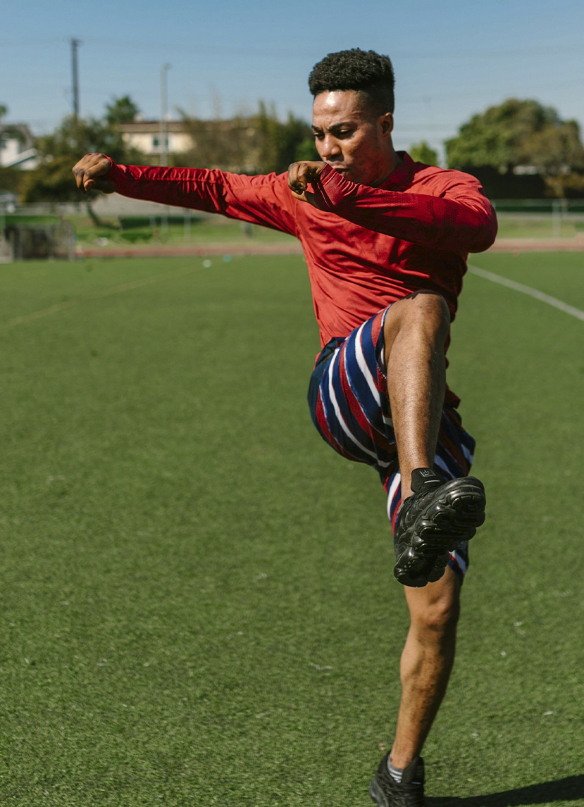 Range of Motion Support - Vitamin K and D Supplements for Motion Man preparing for soccer game - stretching
